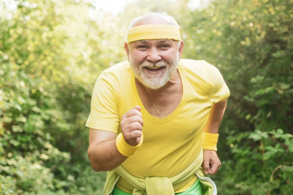 건강 한 사람은 공원에서 건강을 위해 뛰어 다닌다. 노인 이 맑은 자연 속에서 달리고 있어. 건강 한 생활 방식. 스포츠처럼. — 스톡 사진