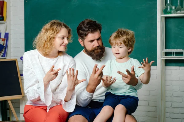 Okul dışı çocuklar için eğitim. İlkokul öğrencisi. Okula ilk kez. Öğretmenler günü. Aile okulu ortaklıkları örnekleri. Veliler okulun ilk gününden önce küçük oğullarını cesaretlendirdi. — Stok fotoğraf