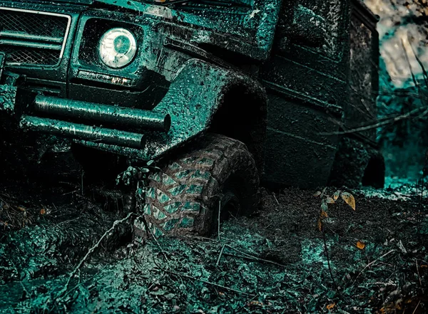 Blick von unten auf großes Offroad-Autorad auf Landstraße und Bergkulisse. Drag-Rennwagen verbrennt Gummi. Extrem. Reifen in Vorbereitung auf das Rennen. Geländewagen kommt aus Schlammloch. — Stockfoto