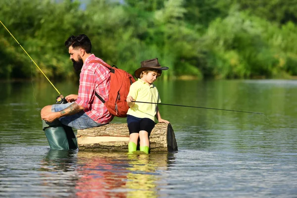 Fishermen father and son fishing in a river with a fishing rod. Fishing. Father and boy son fishing together. — Stock Photo, Image