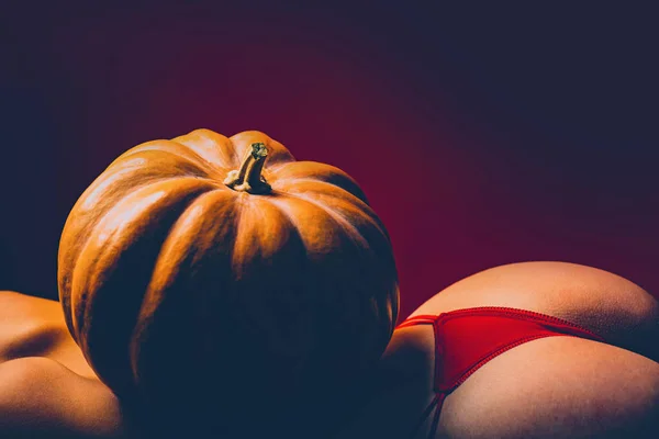 Halloween woman design. Celebrates Halloween. Pumpkin on woman with sexy butt and back. Copy space. Sale on lingerie. Sensual butt with hallowen pumpkin. — Stock Photo, Image