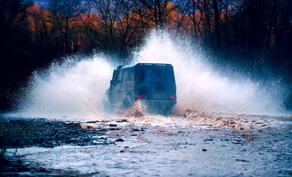 Off road. Suv splash on the river outdoor, traveling on the road. cene of mud splash in off-road racing. Stop action with high speed shutter.