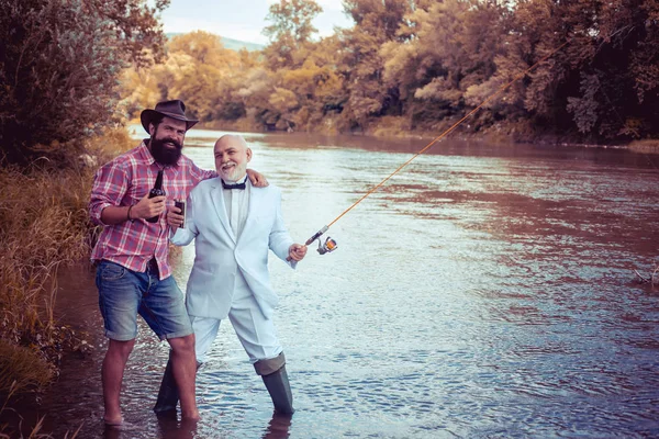 Fly fishing is most renowned as a method for catching trout grayling and salmon. Fly fisherman using fly fishing rod in beautiful river. Man fisherman catches a fish. — Stock Photo, Image