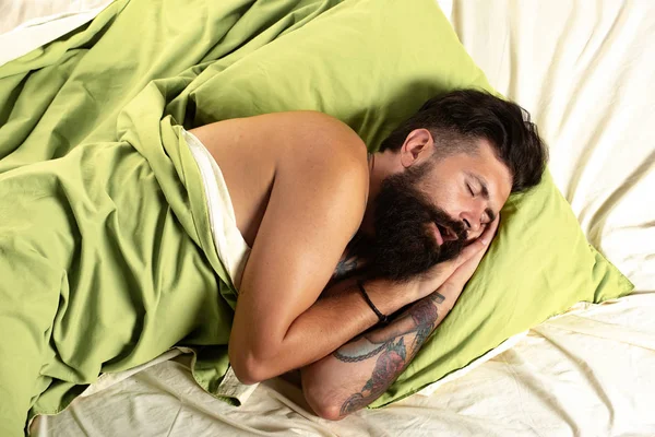 Young man in bed - trying to sleep. Handsome man sleeps in the bedroom - lying on bed. Need some rest. — Stock Photo, Image