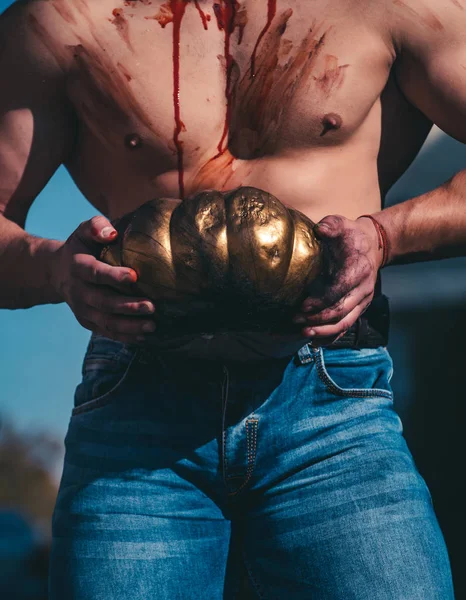 Halloween man with pumpkin in the street. Close-up portrait of a man with zombie makeup. The scary zombie is in the street with pumpkin. Death - young man Halloween portrait. Hot guy. Fitness — Stock Photo, Image