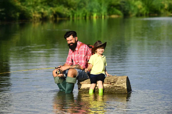 Fishing became a popular recreational activity. Father and boy son fishing together. Anglers. Concept of a retirement age.