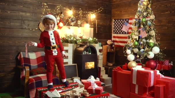 Feliz Natal e Feliz Ano Novo. Criança bonito alegre abrindo um presente de Natal. Desejo-lhe um feliz Natal. Feliz Natal e Boas Festas . — Vídeo de Stock