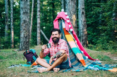 Turizm doğaya dayanıyor. Seyahat eğlence açık hava aktivite konsepti. Dinlenme kampı. Dalların sığınağı. Hovel içinde sakallı adam
