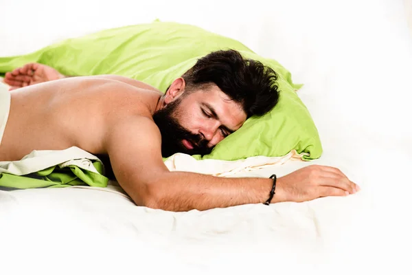 Attractive bearded guy holding in hands pillow in bed. Slumber man. Wake up Sleepy. Need some rest. — Stock Photo, Image