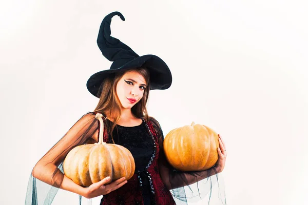 Happy Halloween. Attractive model girl in Halloween costume. Happy young women in witch halloween costumes on party over white isolated background.