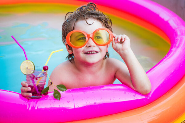 Kids beach fun. Child boy and best swimming pool. Relax in spa swimming pool. Boy happy swimming in a pool. Kids Swimming Pool Concept. Child water toys.