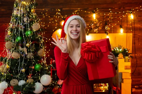 Luxury Christmas woman with gift. Fashionable luxury girl celebrating new year. Thanksgiving day and Christmas. Girl is happy about the new year.