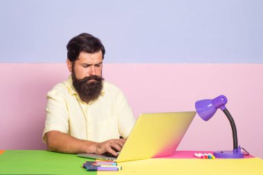 Yakışıklı yönetici dizüstü bilgisayar ile toplantıda dostça konuşma yapıyor. Dizüstü bilgisayar ekranında çalışan ofis çalışanları.