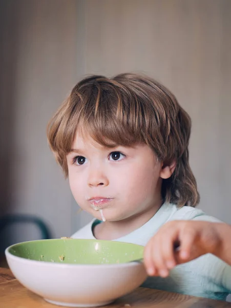 Gelukkig kind. Het kind in de keuken aan de tafel eten. Kleine baby eten. Goedemorgen in gelukkige familie. Zomer rantsoen. — Stockfoto