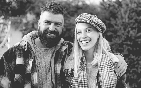 They have own style. Lumberjack style. Couple wear checkered clothes nature background. Man bearded hipster and girl wear kepi hat. Checkered style. Couple handsome bearded hipster and fashion girl