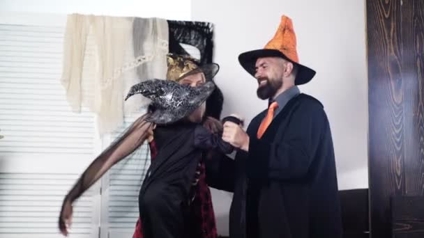 Family having fun on halloween. Happy family celebrating Halloween. Dad with mom and their son in hats and themed costumes scare to halloween. Halloween party. Festive family traditions. Happy family. — Stock Video