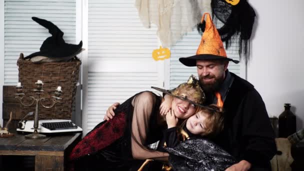Father, mother and son in halloween costumes have fun, hugging and smiling. Boy hugs his mom and father, halloween party at home. Trick or treat. Family Halloween Celebration Traditions. Happy family. — Stock Video