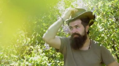 Çiftlikte duygusal komik sakallı hipster. Bahar tarlasında eğlenen mutlu çiftçi. Eco Resort Faaliyetleri. Çiftlikte bahar zamanı. Yeşil çim alan manzara.