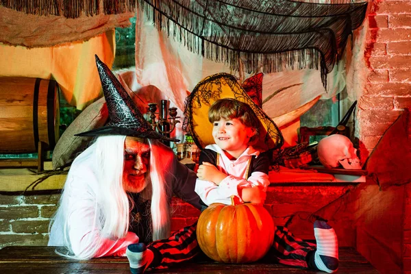 Man and boy scare guests. Happy family father and child in costumes on a celebration of Halloween. — Stock Photo, Image