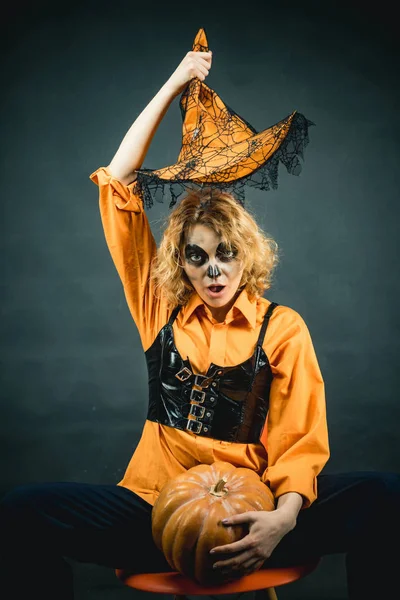 カボチャの女の魔女ハロウィーンパーティーのための吸血鬼の服を着た魔女の帽子を持つ若い女性。魔法の帽子の魔女. — ストック写真