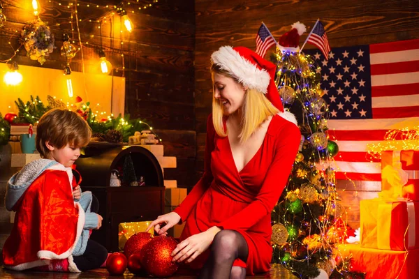 Happy family. Family holiday. Mom and kid decorating together christmas tree. Mother and son friendly having fun. Enjoy every moment together. American traditions concept. Family having fun at home