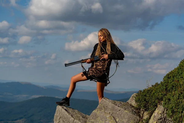 Female with a gun. Closed and open hunting season. Hunter woman with hunting gun. Autumn hunting season. Outdoors active lifestyle. Hunting period summer season.