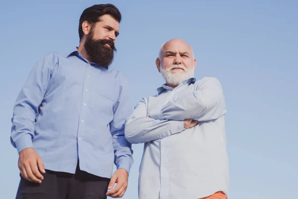 Portrait of two bearded men. Pension concept. Generations men. Grandfather ageing. Men generation. Father and son looking at each other. — Stock Photo, Image
