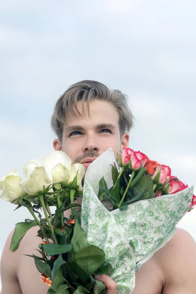 romantic man with rose bouquet. valentines day present. gift with love. ready for date. muscular macho man with flowers. Love you more than yesterday. man in love. birthday present. party celebration
