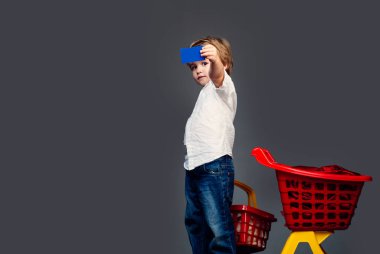 Temassız ödeme. Erkek çocuk alışverişi. Kolay satın alma. Çocuk plastik alışveriş sepeti oyuncak tutun. İndirimli satın alın. Aile alışverişi. Banka kartı. Dükkan çal. Alıcı müşteri müşteri alışveriş sepeti tutun