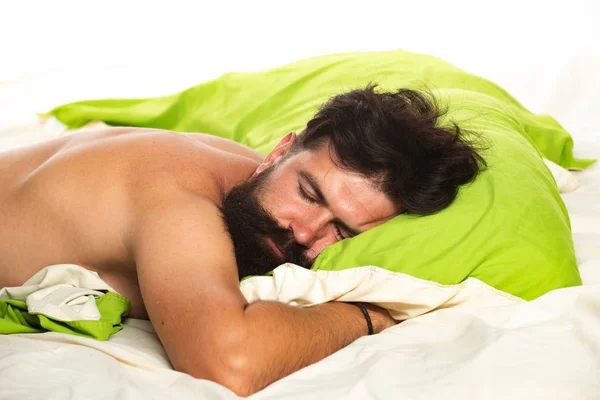 Young man is lying on bed and enjoying the morning. Slumber man. Bored sleepless and tired in bed. Sleeping man. — Stock Photo, Image