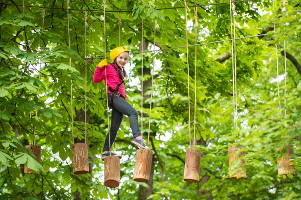 Cute school child boy enjoying a sunny day in a climbing adventure activity park. Children summer activities. Roping park. Every childhood matters. — Stock Photo, Image