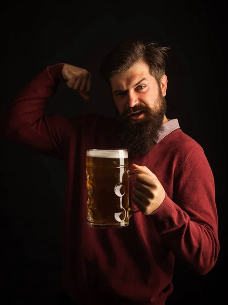 Man holding mug of beer. Bearded man drinking lager beer. Concept of craft beer. Beer in the UK.