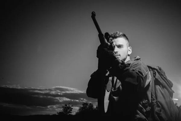 Barrel of a gun. Hunter with shotgun gun on hunt. Hunter with Powerful Rifle with Scope Spotting Animals.