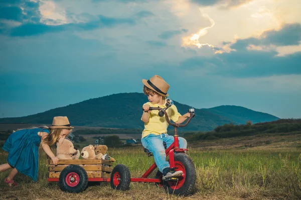 Cute little children enjoying on farm. Childhood memories. Eco resort child activities. Little farmer in village. Summer leisure. Country life. Springtime or summertime for kids on the ranch.