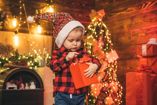 Family holiday. Merry and bright christmas. Lovely baby enjoy christmas. Santa boy little child celebrate christmas at home. Wish list. Childhood memories. Boy cute child cheerful mood christmas gift