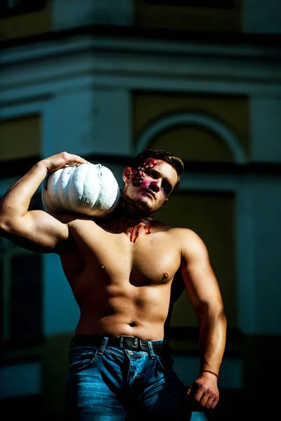 Halloween face art. Half face portrait. Sport and health food, Halloween gourd. Strong man body. Halloween or horror concept - screaming walking dead zombie. Mystery and horror concept. Hot guy. — Stock Photo, Image