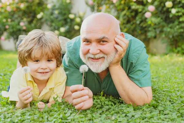 Two different generations ages: grandfather and grandson together. Grandson embrace his grandfather. Grandfather and son. Family summer and active holidays. — Stock Photo, Image