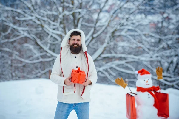 Moderne Kerstman. De Kerstman dronken thuis. Knappe Kerstman. Grappige Kerstman poseren met rode geschenkdoos op winterweer. — Stockfoto
