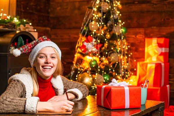 Belle femme dans Santa chapeau helper avec cadeau de Noël dans une boîte rouge. Rituels pour le Nouvel An. Noel et bonheur concept . — Photo