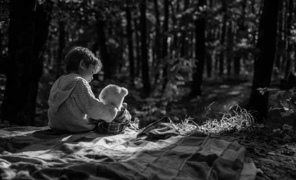 Söt pojke med höstlöv på hösten natur bakgrund. — Stockfoto