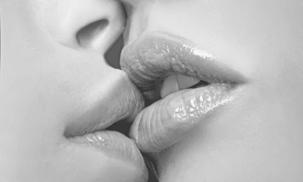 Two lesbian friends kissing. Sensual lips kisses. Passion and sensual touch.