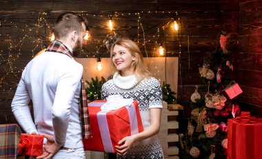 Birbirine aşık bir çift Noel hediyelerini değiş tokuş ediyor. Mutlu aile çifti. Noel arifesi. Xmas ağacı. Yeni yıl. Mutlu Noeller ve mutlu yıllar. İyi bayramlar..