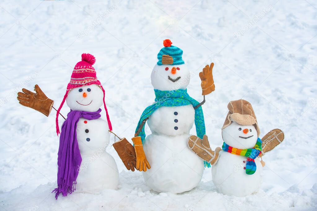 Winter time scene. Snowmen. Christmas background with snowman. Christmas snowman close up with scarf. Snowman in snow forest.