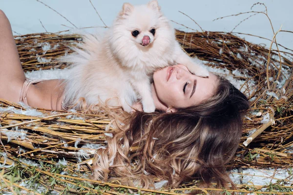 Best softener ever. Fashion model. Attractive woman enjoying softness of feather in giant nest. Pretty easter bird. Pretty girl long hair relaxing in feather bed nest. Cute girl relaxing on feather