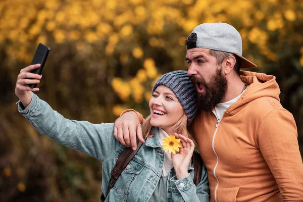 Romantic Autumn couple posing on nature background. Intimate moments for happy lovers. Portrait of beautiful woman and man walking outdoors.