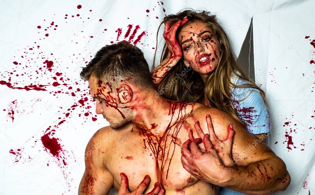 Full of blood. Muscular man in blood. Meatman in butcher shop. Butchery. Bloody halloween couple in love. Together.