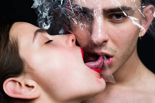 Sexually transmitted diseases. Sexual activity. Sex health. Couple kissing through transparent plastic. Girl sexy tongue lick guy. Safe sex. Oral condom concept. Protecting health. Health protection — Stock Photo, Image