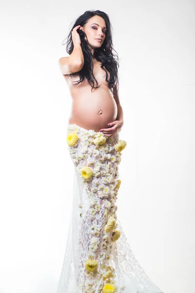 Womens health. girl with big belly. future mother have baby inside. pregnancy. Maternity preparation. life birth expectation. beautiful pregnant woman in spring flower skirt. womens health concept Stock Picture