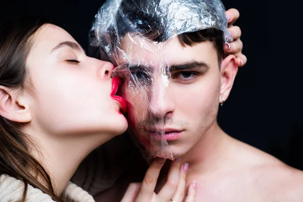 Sexual activity. Sex health. Safety measures. Couple kissing through transparent plastic. Girl sexy tongue lick guy. Safe sex. Protecting health. Health protection. Sexually transmitted diseases — Stock Photo, Image