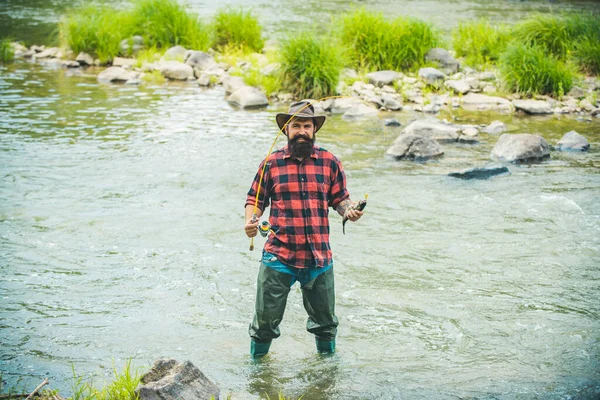 Handsome fisherman in a hat and a red checkered shirt. Fishing as holiday. Man relaxing nature background. It is not sport it is obsession. Master baiter. It is so big. Fishing. — Stock Photo, Image